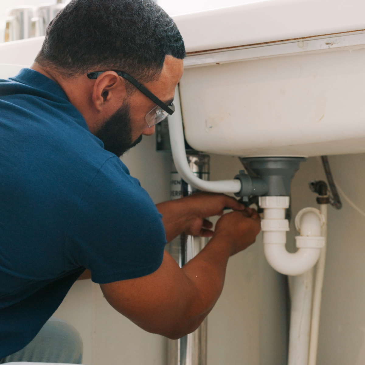 Homecare plumber fixing sink